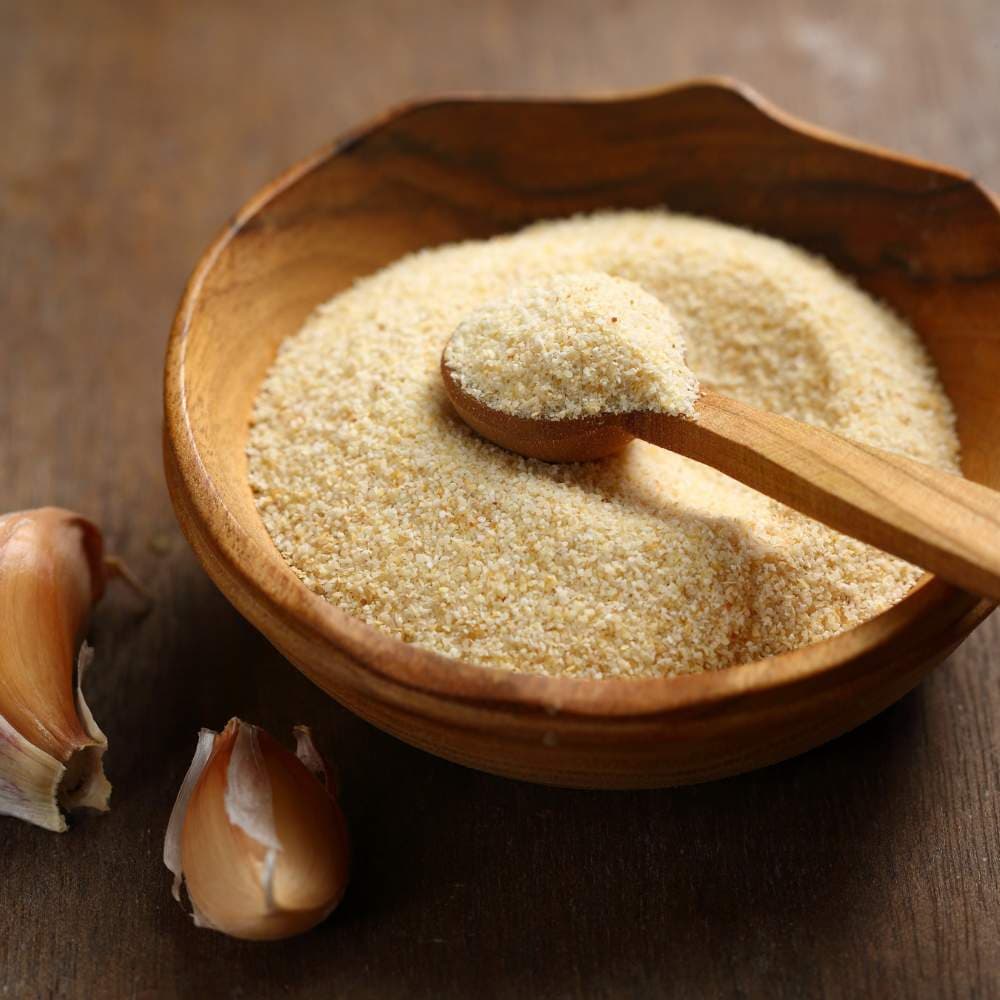 smashed garlic in a wooden bowl